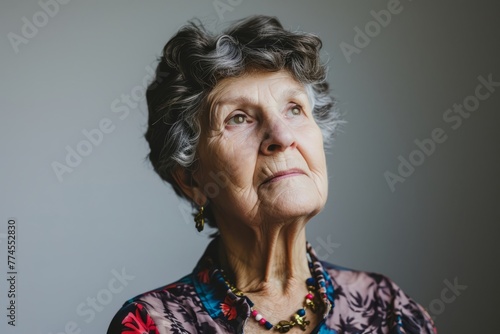 Portrait of a senior woman on a gray background. Toned.