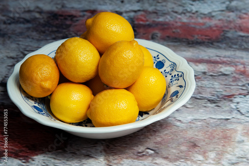 yellow lemons in a blue and white china bowl
 photo