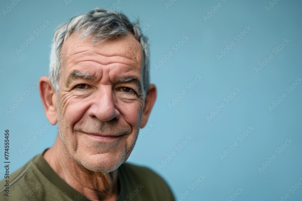 Portrait of a senior man with grey hair on a blue background Portrait of a senior man with grey hair on a blue background
