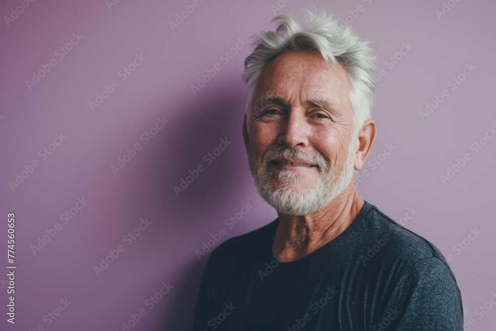 Portrait of a senior man with grey hair and beard on a purple background Portrait of a senior man with grey hair and beard on a purple background