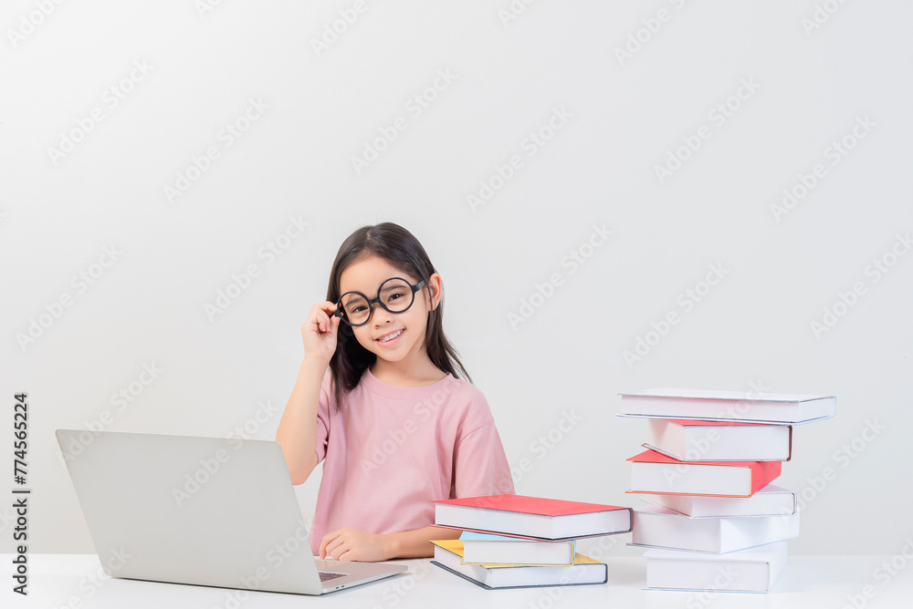 a student on the table and laptop among a large number of books a student on the table and laptop among a large number of books