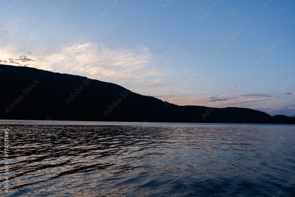 morning on mountain lake with calm water and cloudy sky