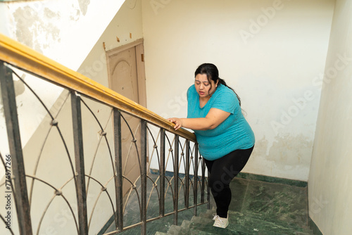 Canvastavla Overweight fat indian woman feeling unwell, not able to breath while climbing stairs