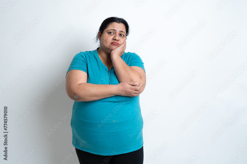 Overweight fat indian woman feeling sad isolated over white background. Plus size female. Healthcare Concept. Copy Space Overweight fat indian woman feeling sad isolated over white background. Plus size female. Healthcare Concept. Copy Space