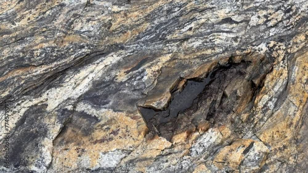 Detailed view of granite rock surface on Bear Island in Scoresbysund, Greenland. Detailed view of granite rock surface on Bear Island in Scoresbysund, Greenland.