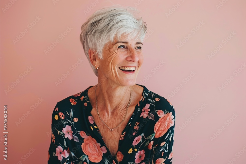Portrait of a happy senior woman smiling at the camera on a pink background Portrait of a happy senior woman smiling at the camera on a pink background