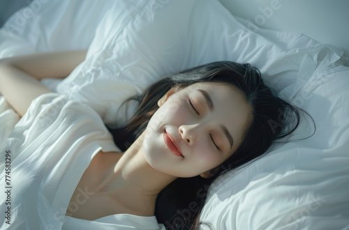A beautiful Korean woman sleeping on her side with white sheets and pillow, she is smiling in dreamy background