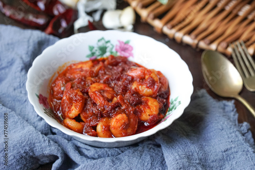 A bowl of chili prawns (sambal udang) on selective focus and blurry background. photo