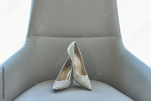 Elegant bridal heels with intricate lace detailing, poised gracefully. photo