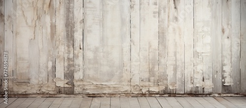 Detailed view of peeling paint on a wall contrasted with a weathered wooden floor photo