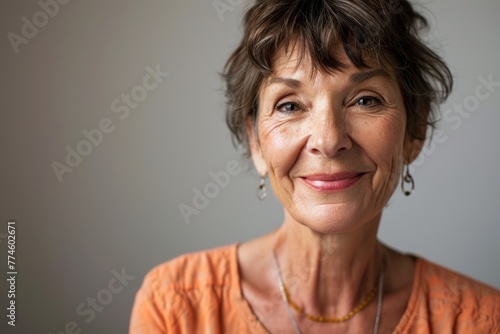 Portrait of a beautiful senior woman smiling at the camera with copy space