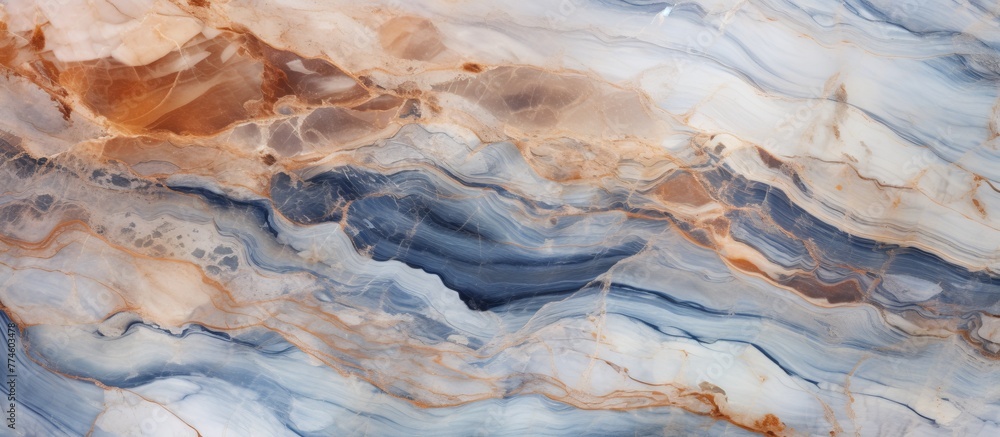 A detailed view of a smooth marble surface showcasing bright shades of blue and orange
