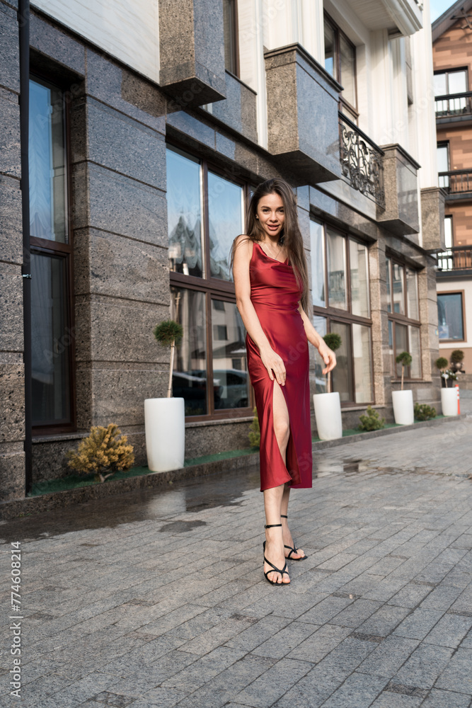 Portrait of a glamorous woman in a red dress.Sexy woman posing for the camera. Portrait of a glamorous woman in a red dress.Sexy woman posing for the camera.