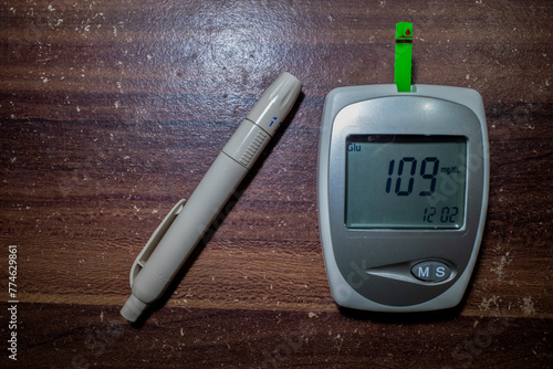 A glucometer and a lancet pen, blood glucose test, measuring glucose level blood test