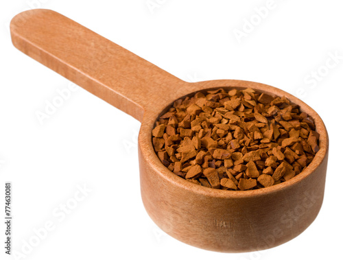 Freeze fried coffee powder in a wooden measuring spoon, isolated on a white background.