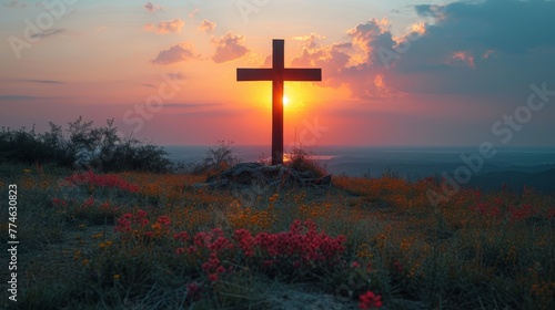  A cross atop a hill as the sun sets, flowers blooming in the foreground