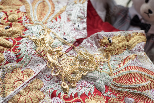 Golden jewelry on embroidered traditional Chinese wedding textile