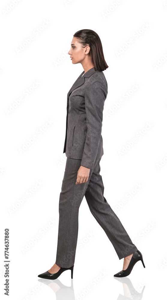 A side profile of a businesswoman walking, in formal wear, on a white isolated background, concept of business motion A side profile of a businesswoman walking, in formal wear, on a white isolated background, concept of business motion