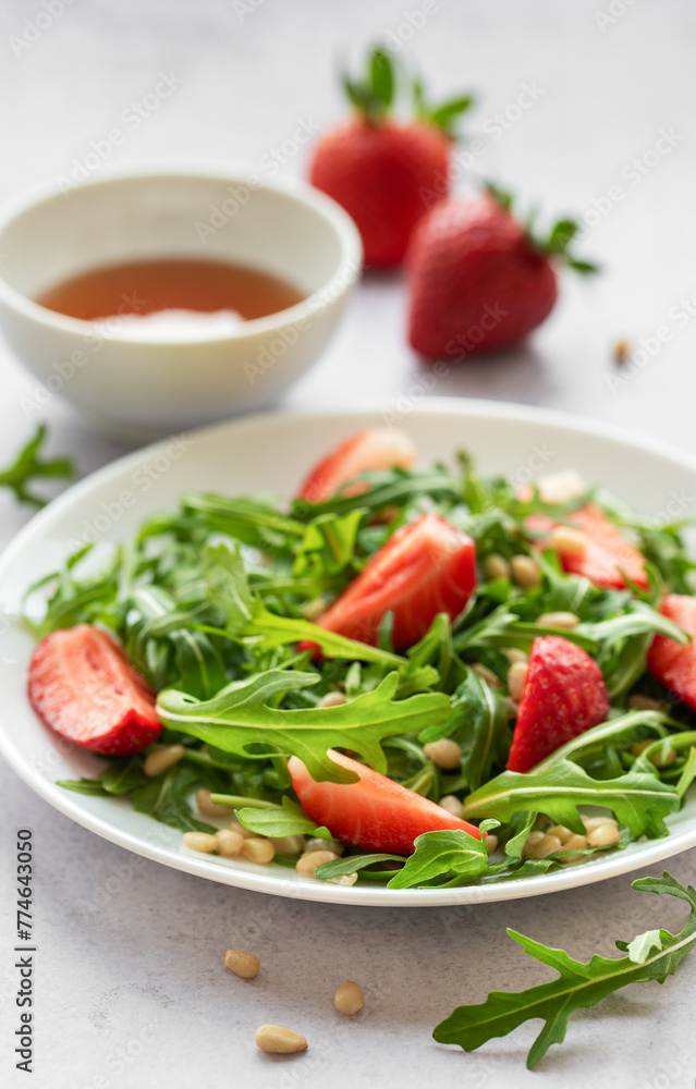 Fresh Strawberry Arugula Salad With Pine Nuts Served on a Bright Day