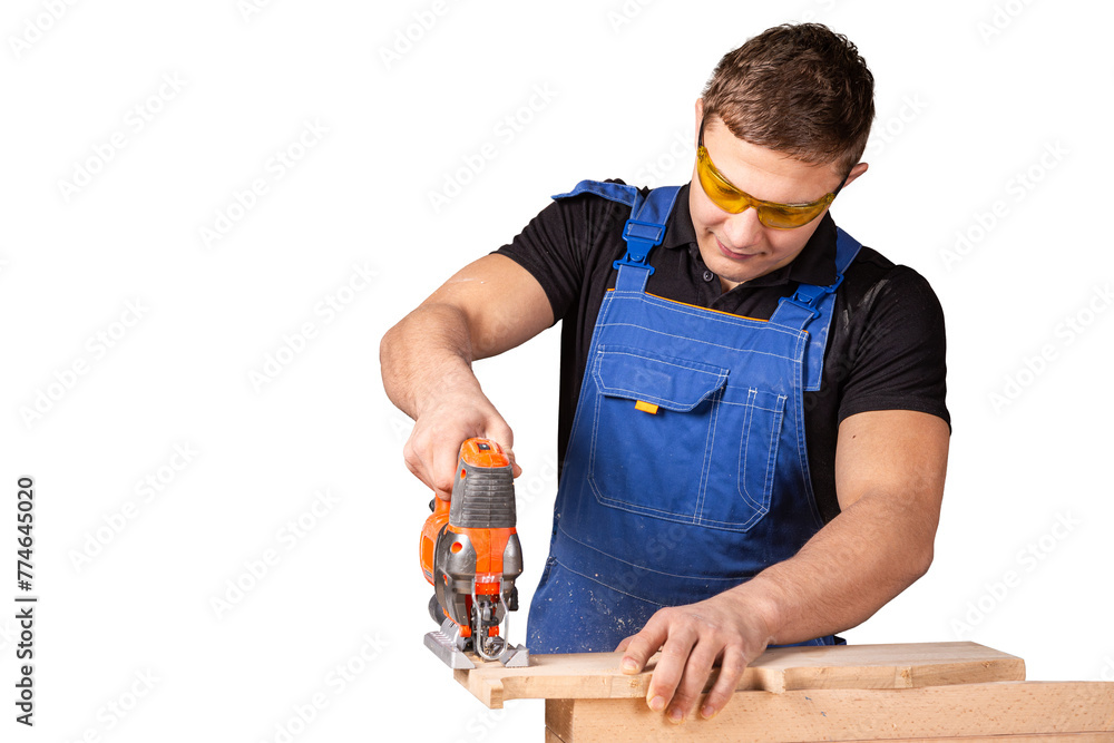 Close up of experienced carpenter in work clothes and small buiness owner carpenter saw and processes the edges of a wooden bar with a jig saw on white background Close up of experienced carpenter in work clothes and small buiness owner carpenter saw and processes the edges of a wooden bar with a jig saw on white background