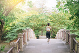 asian woman jogger, running over the bridge in public park.
