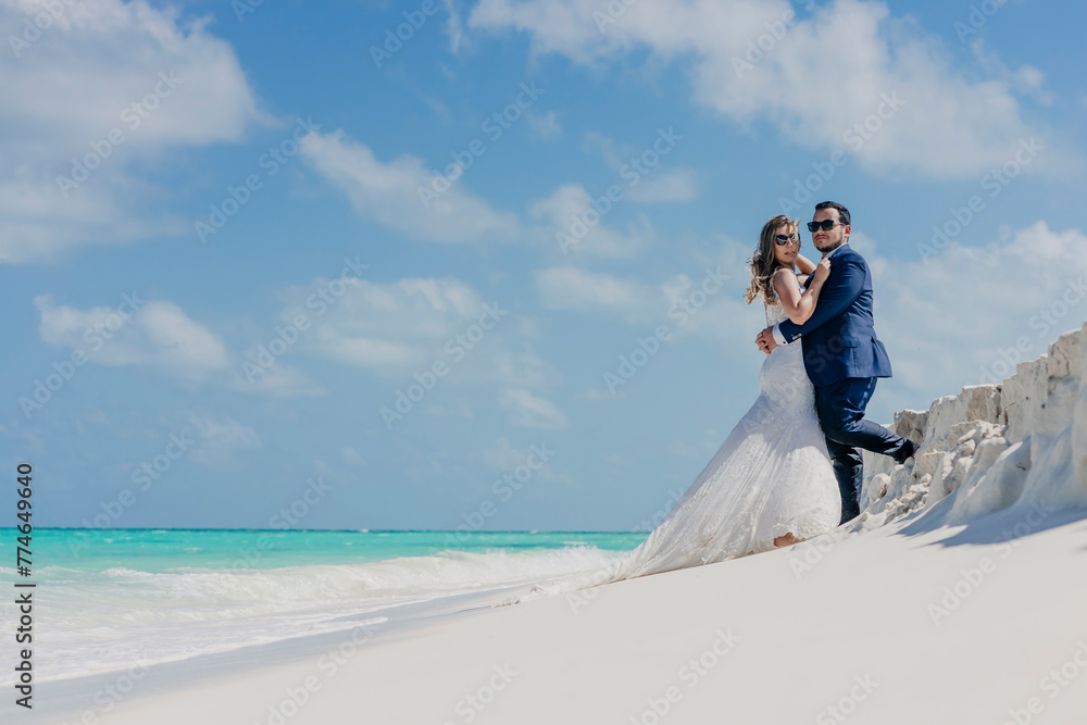 beach with crystal clear waters with a newly married couple