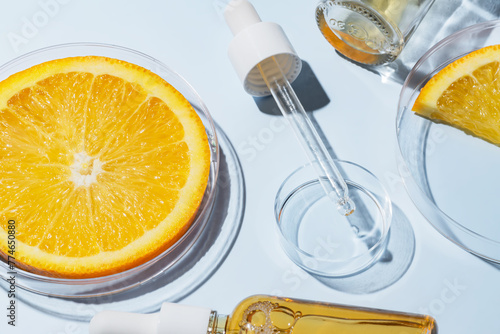 cosmetic laboratory experiment and research with orange and ingredient for natural beauty and organic skincare product. the blank bottle for label, bio science concept. alternative medicine. spa.