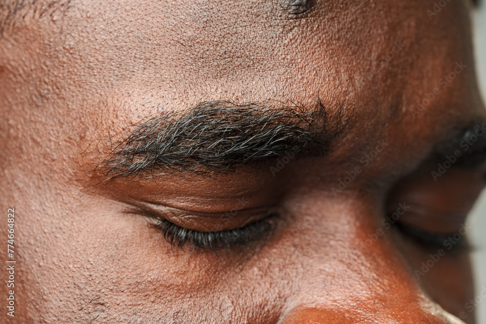 Obraz premium Close Up of African Mans Face With Brown Eyes