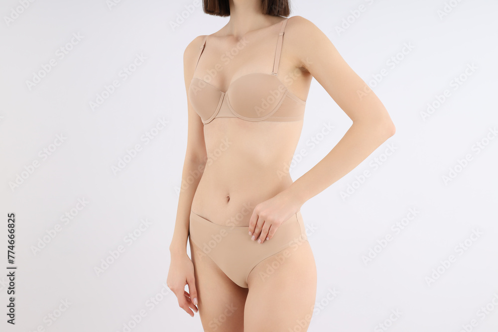 Slim girl in underwear, on a light background. Slim girl in underwear, on a light background.