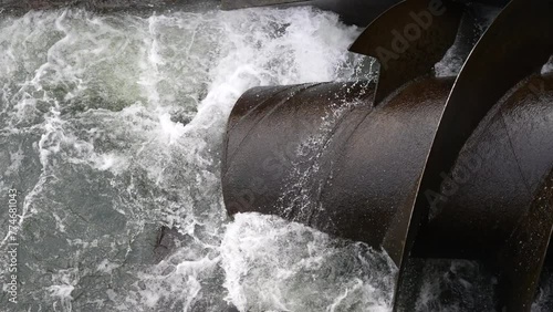 Hydrowater turbine screw making clean 
sustainable river energy electricity with hydroelectric photo