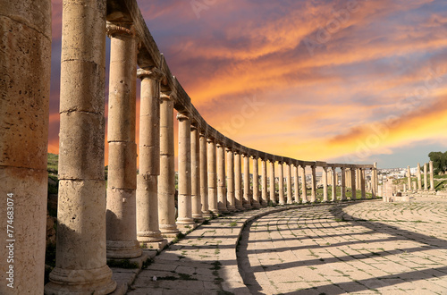 Forum (Oval Plaza) in Gerasa (Jerash), Jordan. Was built in the first century AD. Against the background of a beautiful sky with clouds. photo