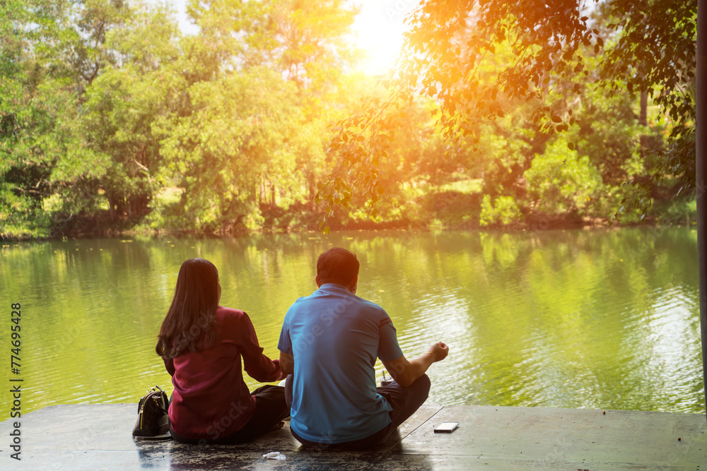 Lover to sit on the terrace near the riverside with sunlight background. Tourist to relax and so happy on holiday.