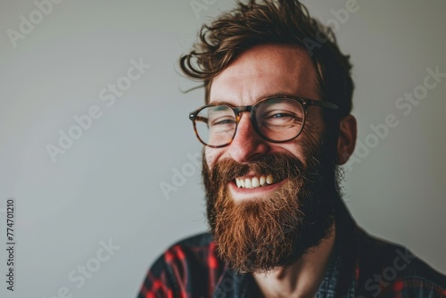 Portrait of a handsome bearded hipster man wearing glasses and a plaid shirt