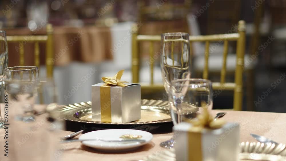 Decorated table for wedding banquet with a gift box for guests Decorated table for wedding banquet with a gift box for guests