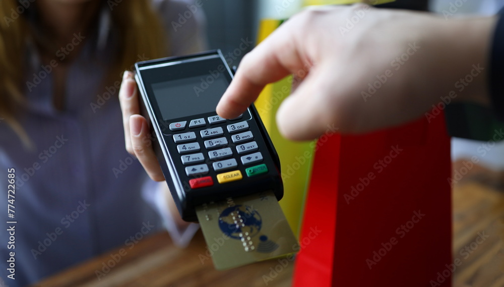 Male hand cuonter push button on modern POS terminal against shop background. Fast payment concept. Male hand cuonter push button on modern POS terminal against shop background. Fast payment concept.