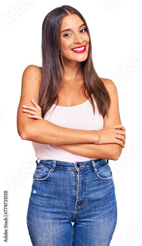 Young hispanic woman wearing casual clothes happy face smiling with crossed arms looking at the camera. positive person.