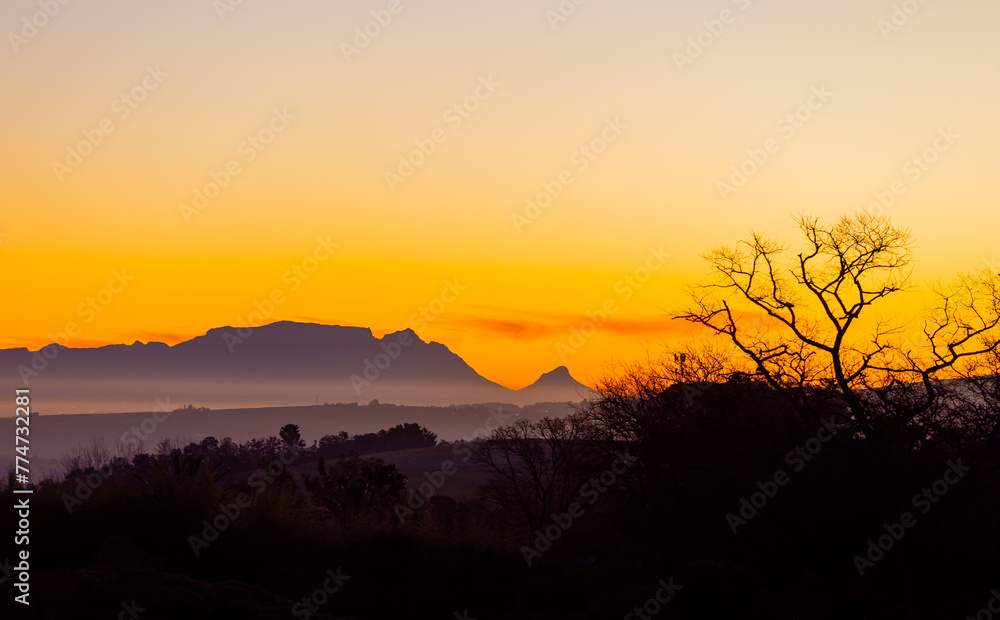 Silhouette of Table Mountain against a dusk sunset sky in Cape Town Silhouette of Table Mountain against a dusk sunset sky in Cape Town