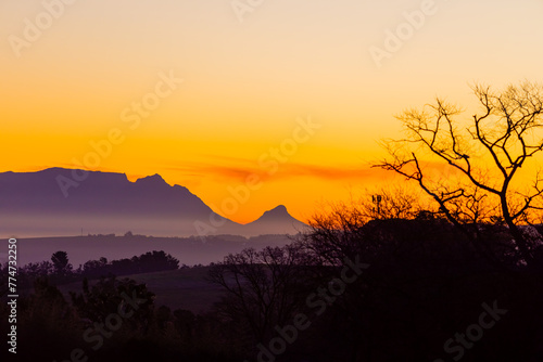 Silhouette of Table Mountain against a dusk sunset sky in Cape Town