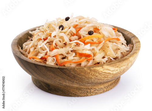 Sauerkraut with carrots and pepper in wooden bowl isolated on white background. With clipping path.