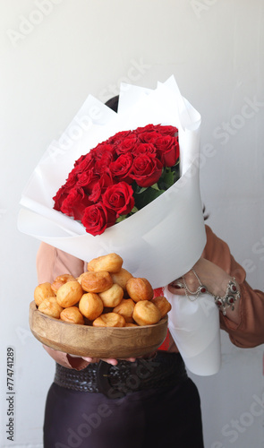 Baursaks and bouquet of red roses