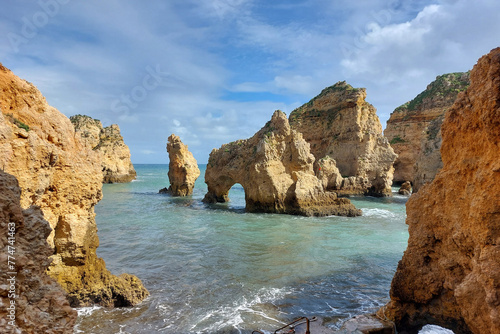 Natural rock formations with sea arch at ocean coast.