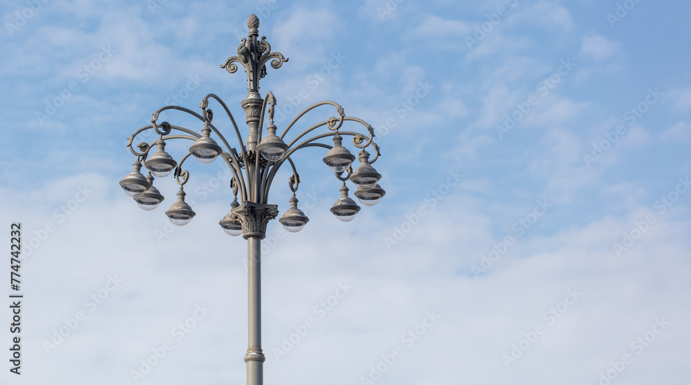 Lamppost against a blue sky with copy space for text