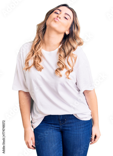 Young caucasian woman wearing casual clothes looking at the camera blowing a kiss on air being lovely and sexy. love expression.