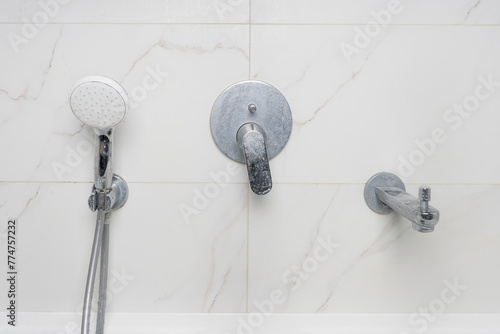 dirty shower faucet covered in limescale and soap stains