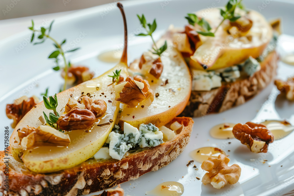 Appetizer bruschetta with pear, honey, walnut and blue cheese on white plate Appetizer bruschetta with pear, honey, walnut and blue cheese on white plate
