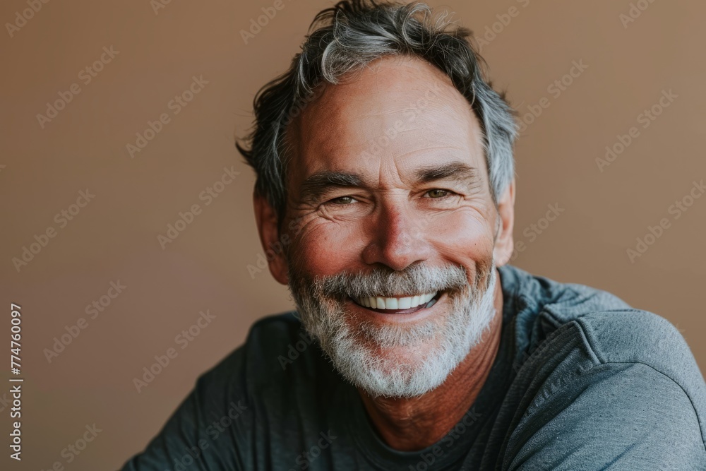 Portrait of a smiling senior man with grey hair and beard. Portrait of a smiling senior man with grey hair and beard.