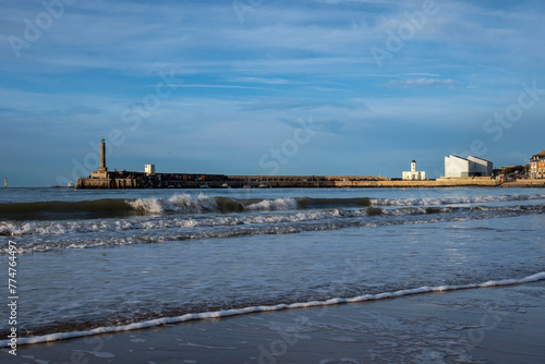 Margate harbour wall and landmarks seen from across the famous beach
