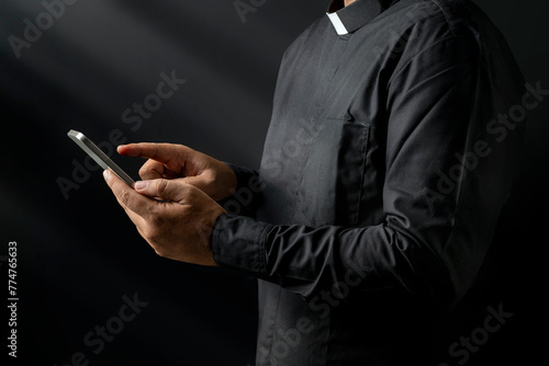 Portrait of a pastor using a mobile phone