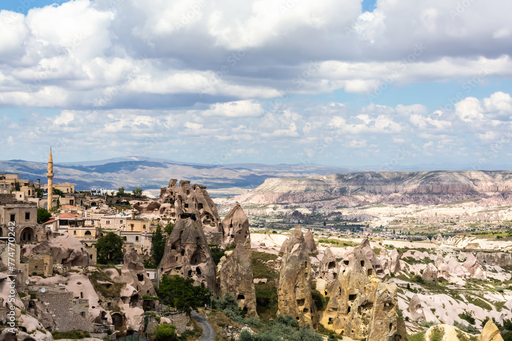 Panoramic view of Uchisar town with its unique rock formations against a dramatic sky in Cappadocia, Turkiye (Turkey)