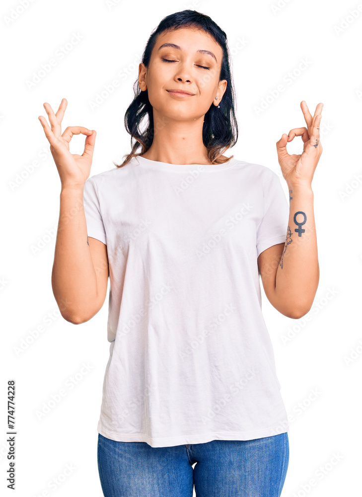 Young woman wearing casual clothes relax and smiling with eyes closed doing meditation gesture with fingers. yoga concept. Young woman wearing casual clothes relax and smiling with eyes closed doing meditation gesture with fingers. yoga concept.